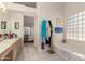 Bathroom featuring a bathtub and vanity with a view into the main bedroom at 2409 S Chestnut Pl, Chandler, AZ 85286