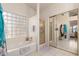 Bathtub with shower and glass block window at 2409 S Chestnut Pl, Chandler, AZ 85286