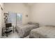 Bright bedroom with tile floors, two twin beds and a window at 2409 S Chestnut Pl, Chandler, AZ 85286