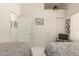 Cozy bedroom featuring two twin beds, white walls, and light tile floors at 2409 S Chestnut Pl, Chandler, AZ 85286