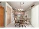 Eat-in kitchen with a decorative chandelier over a glass table with seating for four at 2409 S Chestnut Pl, Chandler, AZ 85286