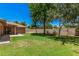 Spacious backyard offers ample green space and shade trees, perfect for outdoor activities at 2956 E Concho Ave, Mesa, AZ 85204