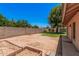 Expansive backyard features a block wall, mature trees, and garden beds, offering a private outdoor space at 2956 E Concho Ave, Mesa, AZ 85204