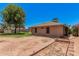 Dirt lot with minimal grass and partial view of the exterior of the home at 2956 E Concho Ave, Mesa, AZ 85204