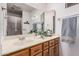 The bathroom features a large mirror and sink with wood cabinets below at 2956 E Concho Ave, Mesa, AZ 85204
