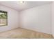 A well-lit secondary bedroom offers neutral walls and carpet and a large window at 2956 E Concho Ave, Mesa, AZ 85204