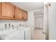Laundry room with side-by-side washer and dryer and oak cabinets for storage at 2956 E Concho Ave, Mesa, AZ 85204