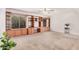 Cozy living room featuring built-in shelving, a ceiling fan, and large windows for natural light at 2956 E Concho Ave, Mesa, AZ 85204