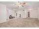 Bright, open living room with neutral carpet, tile entryway, and views into other rooms at 2956 E Concho Ave, Mesa, AZ 85204