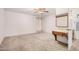 A spacious primary bedroom features neutral carpet, a ceiling fan and ensuite bathroom at 2956 E Concho Ave, Mesa, AZ 85204