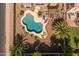 Aerial view of a backyard featuring a uniquely shaped pool, landscaping, and patio furniture at 2990 N Pearl Ct, Casa Grande, AZ 85122