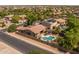 Aerial view featuring swimming pool, covered patio, desert landscaping, and neighborhood at 2990 N Pearl Ct, Casa Grande, AZ 85122
