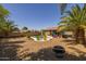 Fully fenced backyard with desert landscaping, pergola, fire pit, and colorful lounge chairs at 2990 N Pearl Ct, Casa Grande, AZ 85122