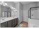Beautiful bathroom features a double sink vanity, a walk-in shower, and a large mirror for a spa-like experience at 2990 N Pearl Ct, Casa Grande, AZ 85122