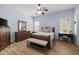 Inviting primary bedroom with natural light, wood floors, and a neutral color palette creating a peaceful and serene space at 2990 N Pearl Ct, Casa Grande, AZ 85122