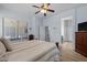 Cozy bedroom featuring wood floors, a ceiling fan, and an ensuite bathroom creating a private and comfortable retreat at 2990 N Pearl Ct, Casa Grande, AZ 85122
