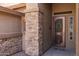 View of the home's entrance featuring a decorative door and beautiful stone accents at 2990 N Pearl Ct, Casa Grande, AZ 85122