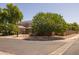 Exterior front view of a home with lush landscaping, mature trees, and a well-manicured lawn at 2990 N Pearl Ct, Casa Grande, AZ 85122