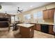Bright kitchen features granite counters, an island, stainless appliances, and room to gather and enjoy your time in the space at 2990 N Pearl Ct, Casa Grande, AZ 85122