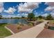 Scenic lake view with lush greenery, bridge access, and a community gazebo, creating a tranquil outdoor space at 2990 N Pearl Ct, Casa Grande, AZ 85122