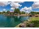 Beautiful lake view with a gazebo, lush landscaping, and a charming bridge in a tranquil community setting at 2990 N Pearl Ct, Casa Grande, AZ 85122