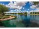 Beautiful lake with a gazebo, lush landscaping, and mature trees offering a serene community space at 2990 N Pearl Ct, Casa Grande, AZ 85122