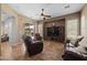 Comfortable living room with tile flooring, ceiling fan, and a sliding glass door leading to the outdoor patio area at 2990 N Pearl Ct, Casa Grande, AZ 85122