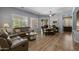Open concept living space with neutral colors, modern furnishings, and beautiful hardwood floors at 2990 N Pearl Ct, Casa Grande, AZ 85122