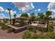 Neighborhood park featuring shaded seating area and playground nestled within lush landscaping at 2990 N Pearl Ct, Casa Grande, AZ 85122