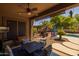 Relaxing covered patio with a ceiling fan, outdoor seating, and views of the backyard at 2990 N Pearl Ct, Casa Grande, AZ 85122
