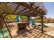 Charming pergola featuring a bar, chairs, and a swing, perfect for outdoor relaxation at 2990 N Pearl Ct, Casa Grande, AZ 85122
