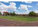 Neighborhood park featuring playground with shade structure, grassy area, and walking path at 2990 N Pearl Ct, Casa Grande, AZ 85122