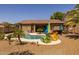 Enjoy a backyard oasis featuring a sparkling pool, tropical landscaping, and a relaxing pergola at 2990 N Pearl Ct, Casa Grande, AZ 85122