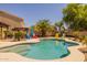 Sparkling backyard pool with ample seating, lush tropical landscaping, and sunny skies at 2990 N Pearl Ct, Casa Grande, AZ 85122