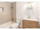 Bright bathroom with a shower-tub combo, warm-toned tile, and wood vanity at 3118 W Windrose Dr, Phoenix, AZ 85029
