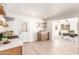 Open kitchen with modern appliances, floating shelves, and an adjacent dining room at 3118 W Windrose Dr, Phoenix, AZ 85029