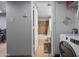 Hallway view leading to a full bathroom and laundry area, enhancing convenience and functionality at 357 E Thomas Rd # A208, Phoenix, AZ 85012