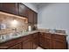 Updated kitchen features stainless steel appliances, tile backsplash, and wood cabinets at 357 E Thomas Rd # A208, Phoenix, AZ 85012