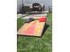 Backyard cornhole game set up on artificial turf creates the perfect spot for outdoor fun and entertainment at 3814 N 36Th St, Phoenix, AZ 85018