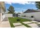 This backyard boasts artificial turf, cornhole, and attractive desert landscaping for low-maintenance enjoyment at 3814 N 36Th St, Phoenix, AZ 85018
