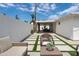 A stylish backyard with clean lines, artificial turf, and a covered patio for relaxation and entertainment at 3814 N 36Th St, Phoenix, AZ 85018