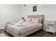 Relaxing bedroom features a tan upholstered bed frame, wood floors and modern nightstand at 3814 N 36Th St, Phoenix, AZ 85018