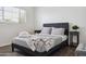Relaxing bedroom features a gray upholstered bed frame, wood floors and modern nightstands at 3814 N 36Th St, Phoenix, AZ 85018