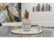 Close up of decorative pineapple with white and gold accents on tray at 3814 N 36Th St, Phoenix, AZ 85018