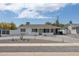Charming single-story home featuring a well-manicured front yard, stylish gray brick driveway, and freshly painted white exterior at 3814 N 36Th St, Phoenix, AZ 85018