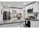 Bright and modern kitchen with stainless steel appliances, white cabinetry, gray countertops, and a stylish island at 3814 N 36Th St, Phoenix, AZ 85018