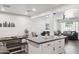 Bright and modern kitchen with white cabinets, gray countertops, stainless appliances, and an open-concept layout to the living area at 3814 N 36Th St, Phoenix, AZ 85018