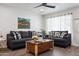 Spacious living room featuring matching sofas, modern decor, wood floors, and a large window at 3814 N 36Th St, Phoenix, AZ 85018