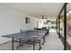 Covered outdoor patio with ping pong table and ample seating offers year-round enjoyment and recreation at 3814 N 36Th St, Phoenix, AZ 85018