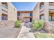 A well-maintained exterior view of the apartment complex with landscaped grounds and walkways at 3825 E Camelback Rd # 182, Phoenix, AZ 85018